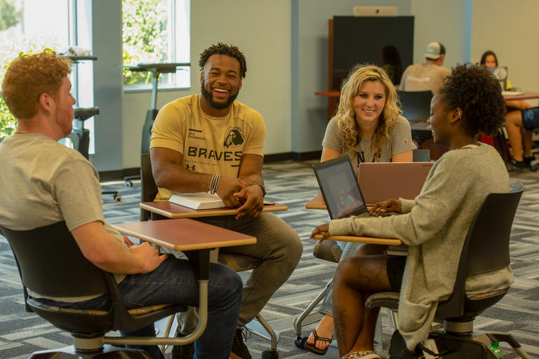 UNCP students study together in the library.