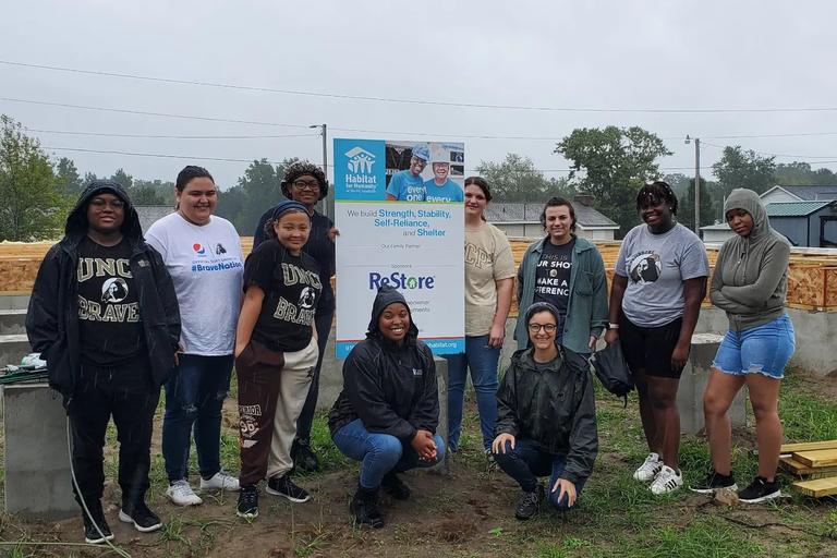 Students volunteering at habitat for humanity.