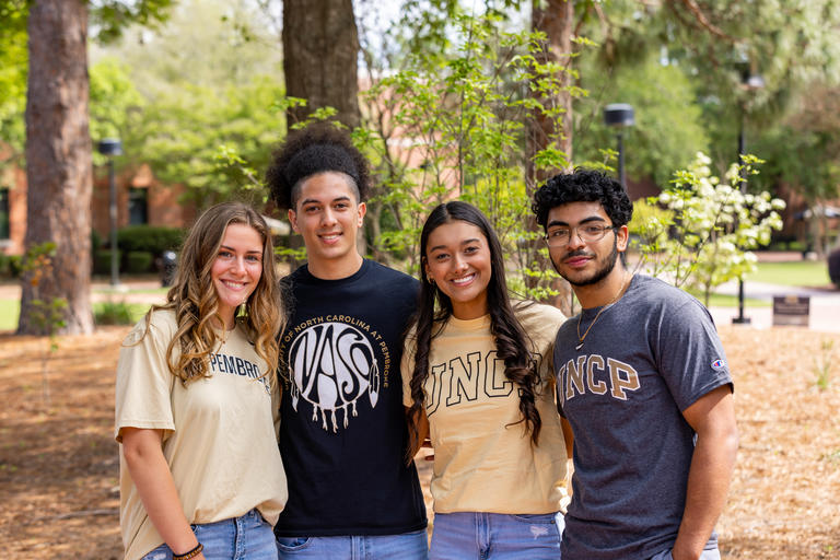 Group of undergraduate students standing together in the quad
