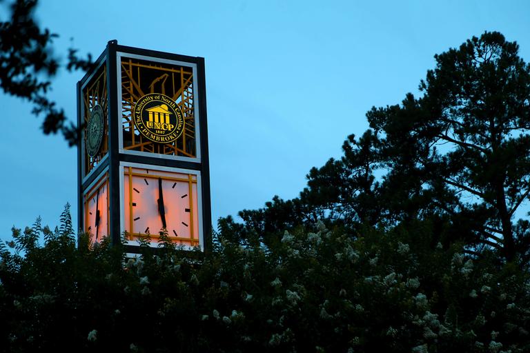 UNCP clock tower at night on the campus of UNCP